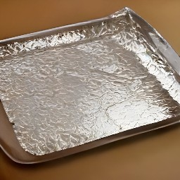 the cookie sheet is lined with aluminum foil and sprayed with cooking spray.