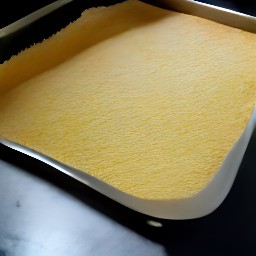 a sheet pan with parchment paper and cornmeal sprinkled over it.