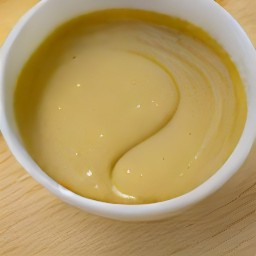 the output is a bowl of yellow mustard, mayonnaise, honey, rice vinegar, and sesame oil that is well blended.