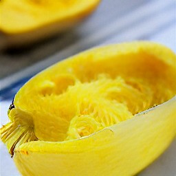the roasted spaghetti squash is cut halfway.