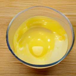 a bowl of eggs that have been cracked and mixed with butter and buttermilk.