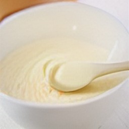 a bowl of whisked eggs with ground cinnamon, maple syrup, and whole milk.