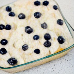 the egg mixture has been drizzled into the glass baking dish and covered with foil. it has been chilled in the refrigerator for 24 hours.