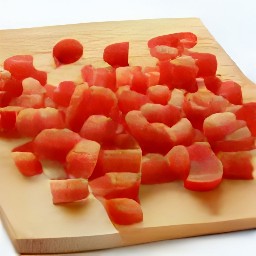 garlic that has been peeled and chopped, and tomatoes that have been diced.