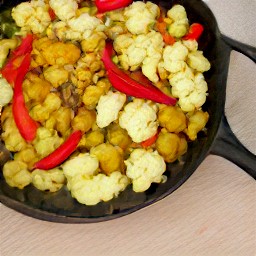 a dish of cauliflower and potatoes cooked in spices including fenugreek, fennel, cumin, and chili peppers.