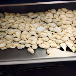 after 15 minutes, remove the baking sheet from the oven and stir the pumpkin seeds with a wooden spoon. return the baking sheet to the oven and bake for an additional 15 minutes, or until golden brown.