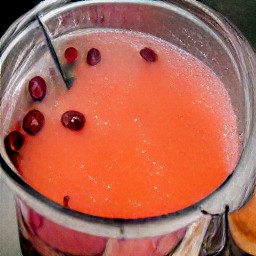 a cocktail made with cranberries, grenadine syrup, chopped pineapple and orange juice.