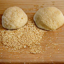 the dough balls are rolled into the breadcrumbs.
