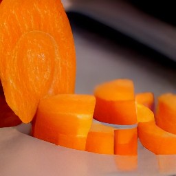 carrots that are sliced, coriander that is chopped, and red chili peppers that are deseeded.