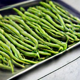 a roll pan full of green beans that have been drizzled with olive oil and sprinkled with kosher salt and black pepper.