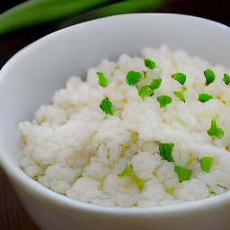 a bowl of ginger rice with garlic-scallion mixture and salt.