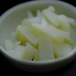 garlic that is peeled and minced, and scallions that are trimmed and sliced.
