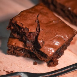 

Fudge brownie is a delicious, rich dessert made with butter, sugar, cocoa powder, eggs and flour. It's topped with chocolate chips and pecans for extra indulgence.