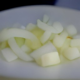 after peeling the onion and garlic, chop them. then, remove the kale stems.