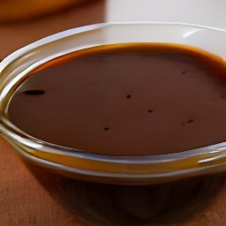 a bowl of chopped garlic mixed with balsamic vinegar, yellow mustard, honey, and salt. the mixture is then covered with cling film and refrigerated for 120 minutes.