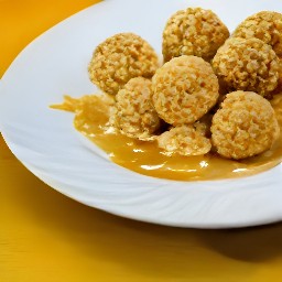 a batch of corn flake and peanut butter cookies that are cooling on wax paper.