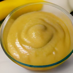 a bowl containing an egg that has been cracked and mixed with bananas, sugar, and butter.