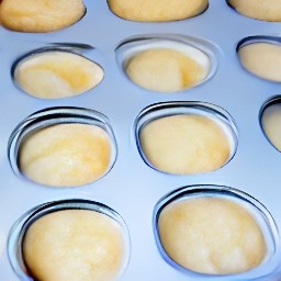 a muffin tin that is 2/3 full of batter.
