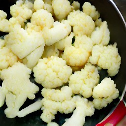 a pan of cooked cauliflower with garlic.