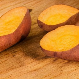 the sweet potato halves are coated in olive oil.