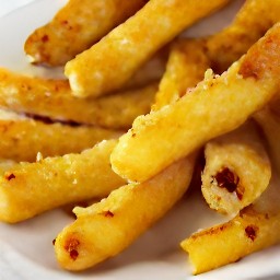 the heat is turned off and the baking sheet is taken out of the oven. the peppery turnip fries are transferred to a platter and drizzled with lime juice.