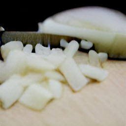 a peeled onion and garlic that are chopped.