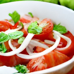 a bowl of tomato, onion, basil, olive oil, and oregano salad.