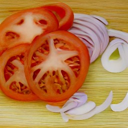 sliced tomatoes, chopped basil, peeled sweet onions that are cut lengthwise into strips.