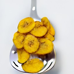 the fried plantains are transferred to a slotted spoon over a kitchen paper to remove excess oil.