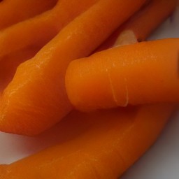 the carrots peeled and there carrot peels in the sink.