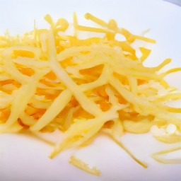 the cheddar cheese is transferred to a plate.