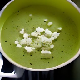 the feta cheese mixture is put into the green soup.