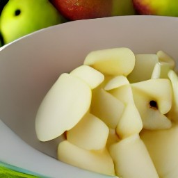 a bowl of apple filling mixed with lemon juice.