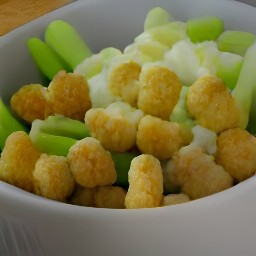 a bowl of soup with tater tots mixed in.