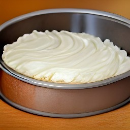 a cake with a creamy mixture spread over it.