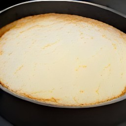 the milk mixture is poured over the cake.