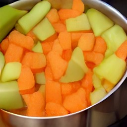 a pot of soup with cooked veggies.
