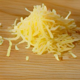 the swiss cheese in small pieces after being shredded with a grater.