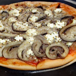 a pizza with a crust made from the mix, topped with onions, portabella mushrooms, feta cheese, and thyme.
