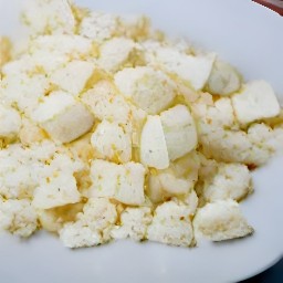 the feta cheese is crumbled into small pieces.