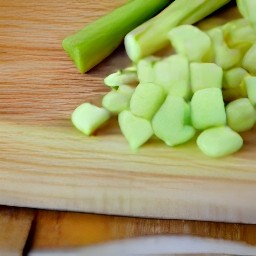 after peeling the onions and chopping them, chop the celery sticks and peel the garlic.