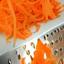 the carrots shredded into thin pieces using the grater.