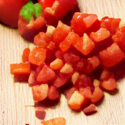 green onions that are sliced and red bell peppers that are destalked and chopped into small pieces.