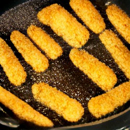 the cheese slices are fried on one side for 2 minutes, then flipped with a spoon and fried for 2 more minutes. then they are removed from the heat.