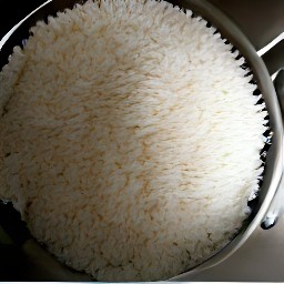 the white rice is drained in the colander.