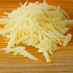 the swiss cheese has been shredded into small pieces.