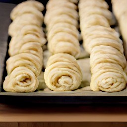 the rolled puff pastry is in a tray.