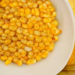 the sweetcorn is transferred to a plate.