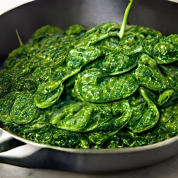 a dish of spinach and garlic cooked in butter and olive oil, with lemon juice added.