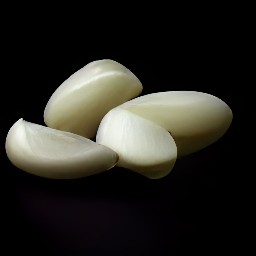 garlic that has been peeled and minced, and tomatoes that have been chopped.